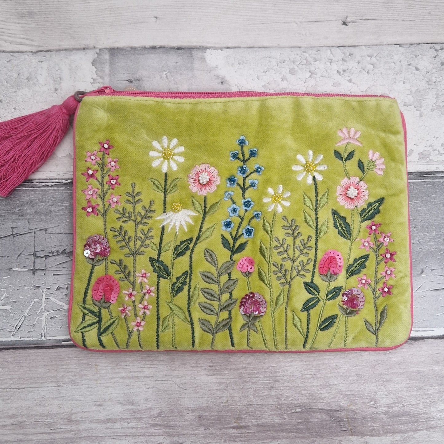 Lime velvet pouch decorated with embroidered flowers. Finished with hand sewn beading.