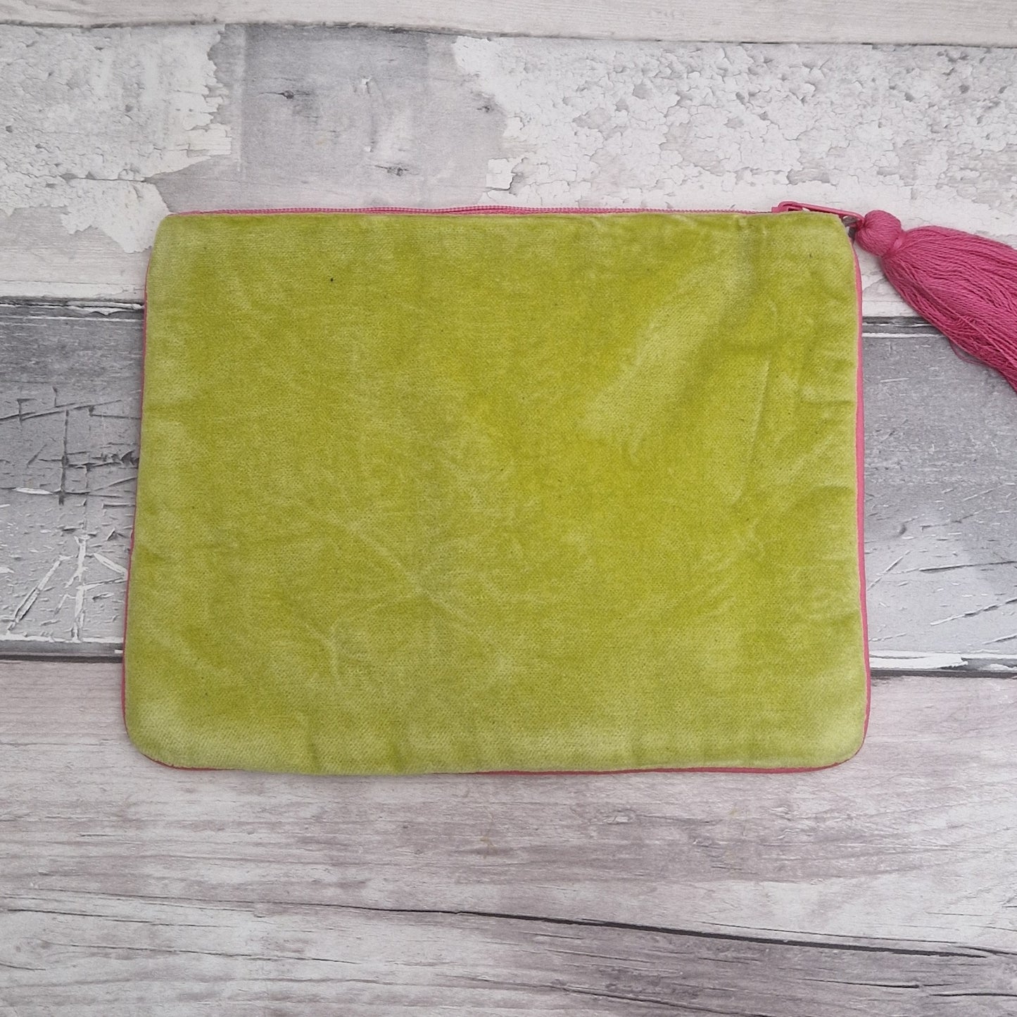 Rear view of lime green velvet pouch.