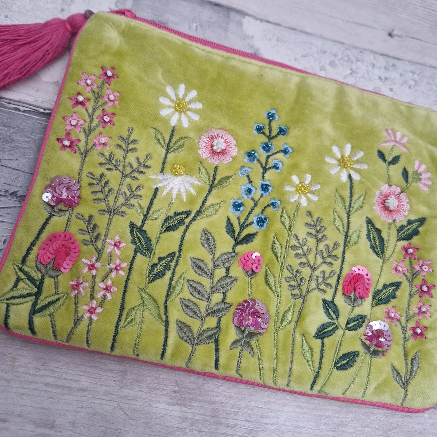 Lime velvet pouch decorated with embroidered flowers. Finished with hand sewn beading.