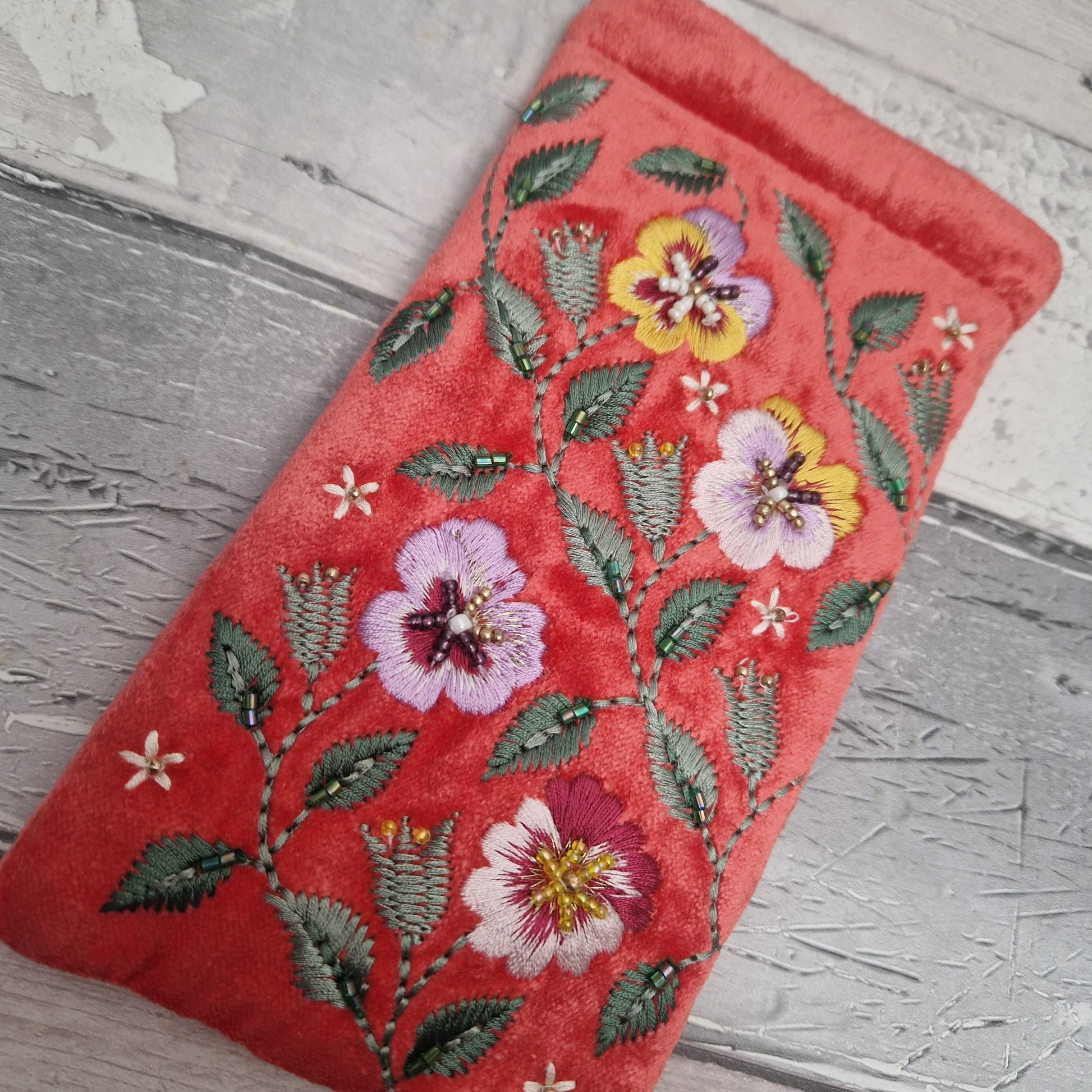 Salmon Pink Velvet glasses case decorated with embroidered purple and yellow pansies. Finished with intricately sewn beading.