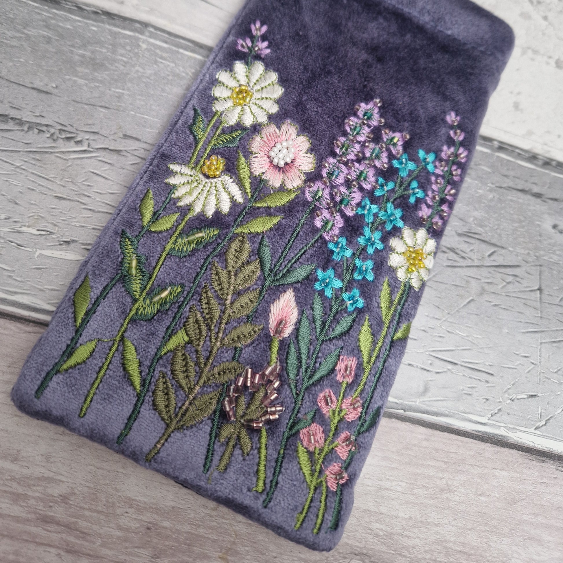 Lilac coloured velvet glasses case decorated with embroidered flowers and finished with hand sewn beads.