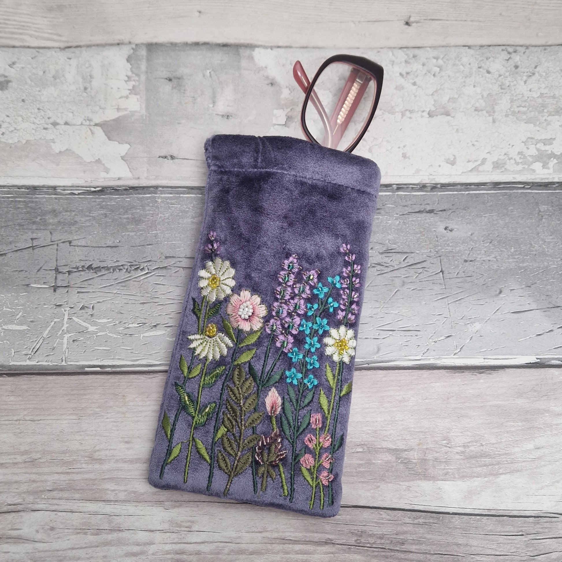 Lilac coloured velvet glasses case decorated with embroidered flowers and finished with hand sewn beads.