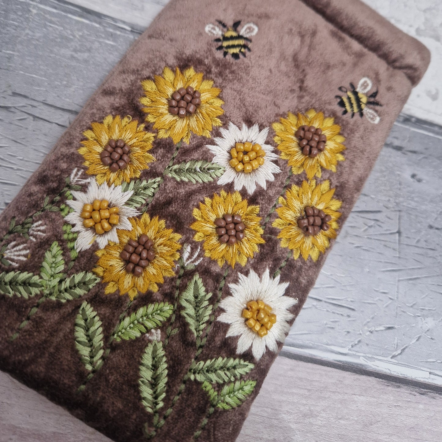 Brown coloured velvet glasses case decorated with embroidered sun flowers and bees. Finished with hand sewn beads.