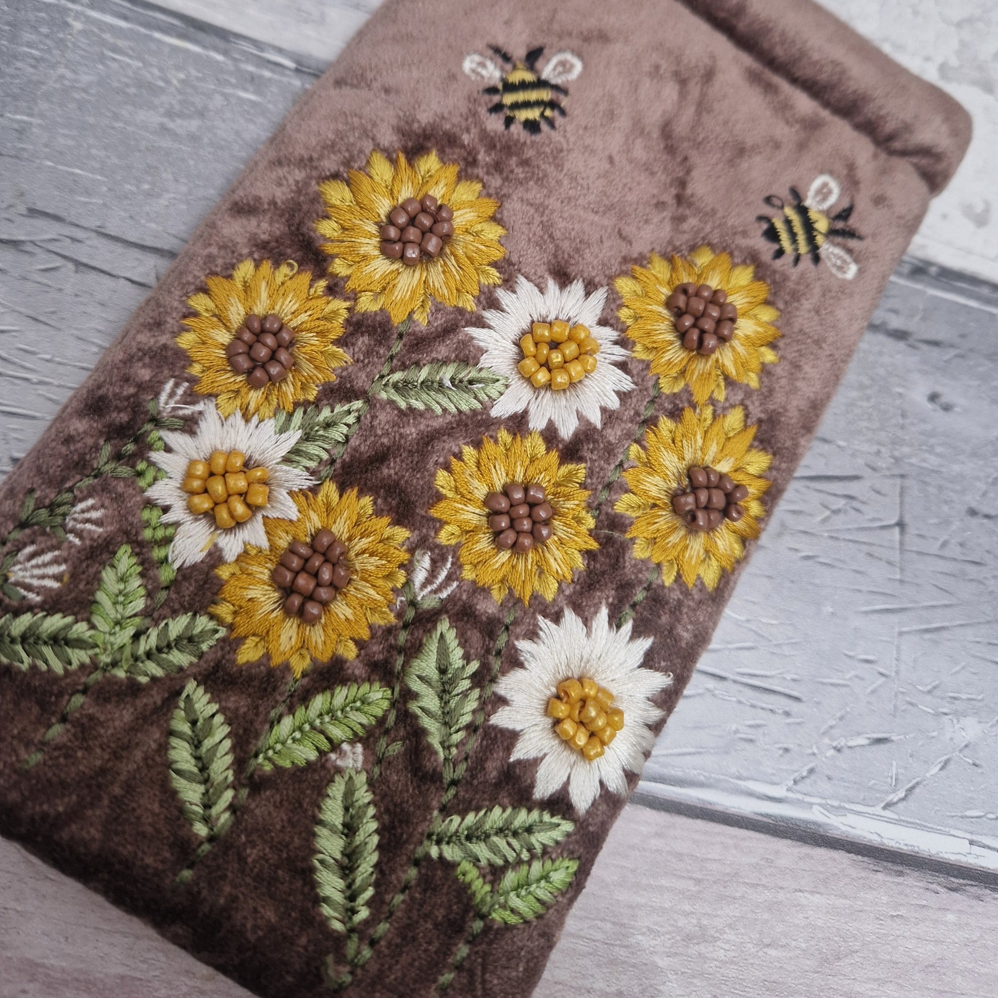 Brown coloured velvet glasses case decorated with embroidered sun flowers and bees. Finished with hand sewn beads.