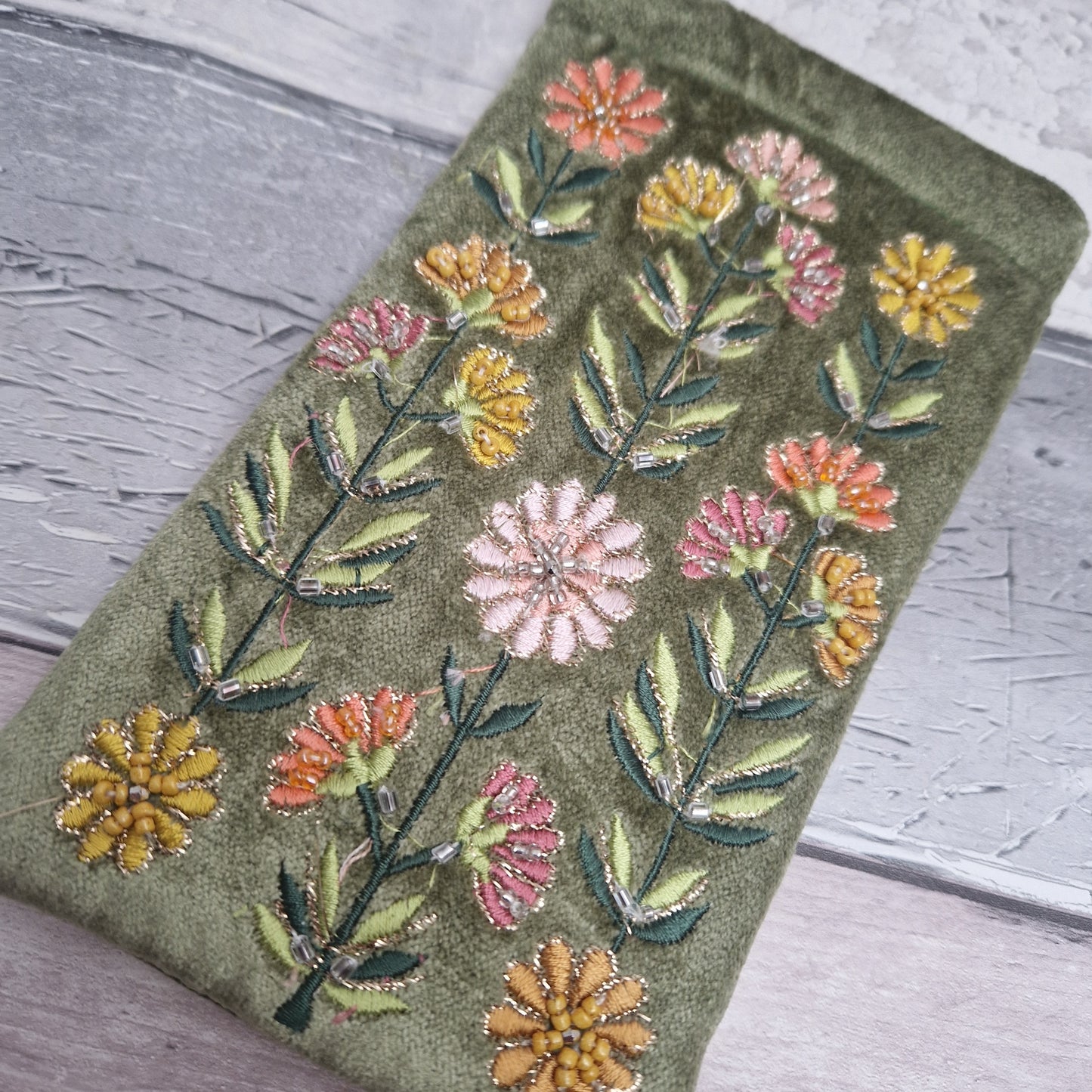 Green coloured velvet glasses case decorated with Gerbera flowers. Finished with hand sewn beads and metallic thread.