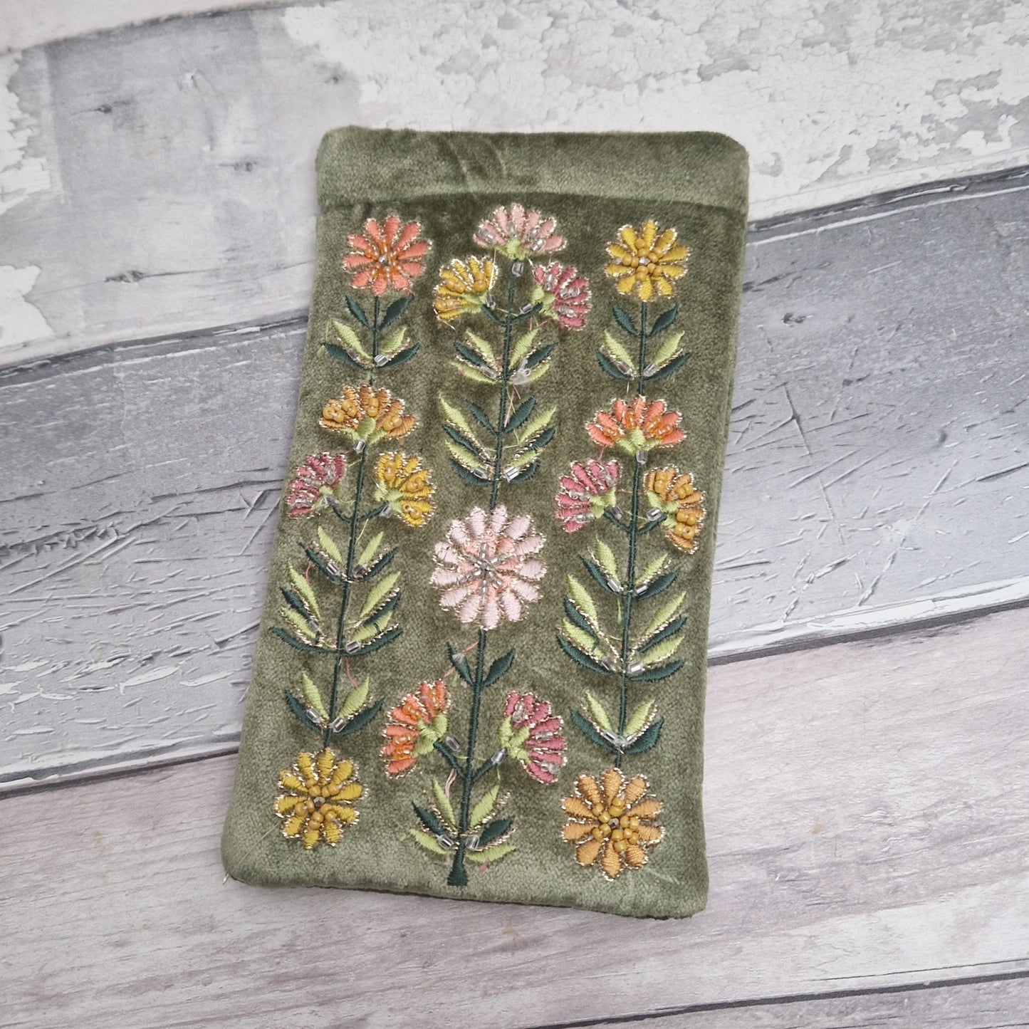 Green coloured velvet glasses case decorated with Gerbera flowers. Finished with hand sewn beads and metallic thread.