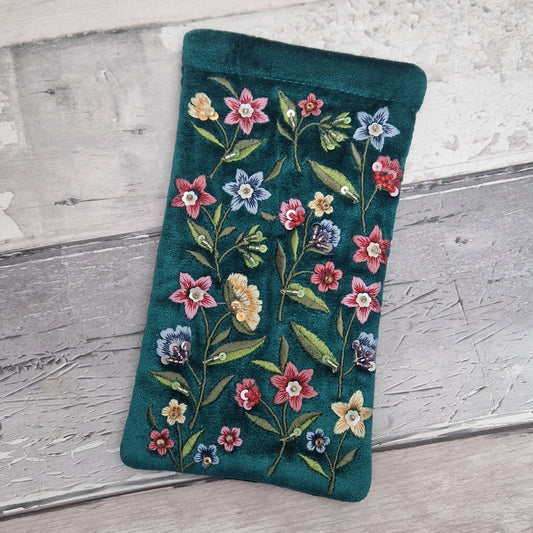 Turquoise coloured velvet glasses case decorated with embroidered wildflowers in red, yellow and blue on green stems. Finished with hand sewn sequins and beads.
