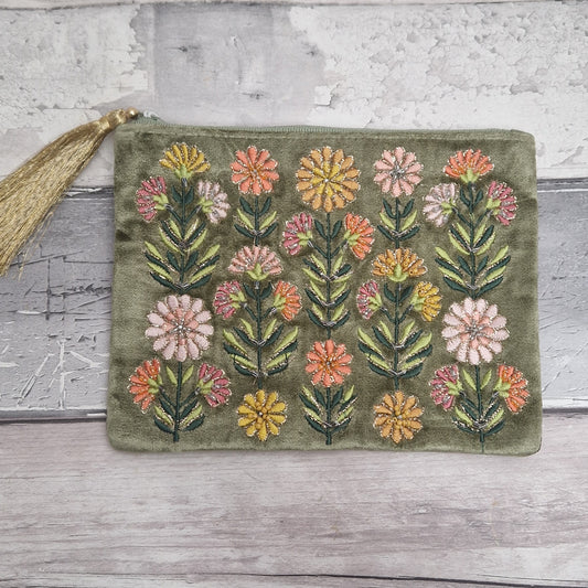 Green coloured velvet pouch decorated with embroidered Gerbera flowers in pink, yellow and orange on green stems. Finished with hand sewn sequins and metallic thread.