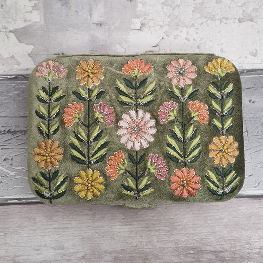 Green coloured velvet jewellery box decorated with embroidered Gerbera flowers in pink, yellow and orange on green stems. Finished with hand sewn sequins and metallic thread.
