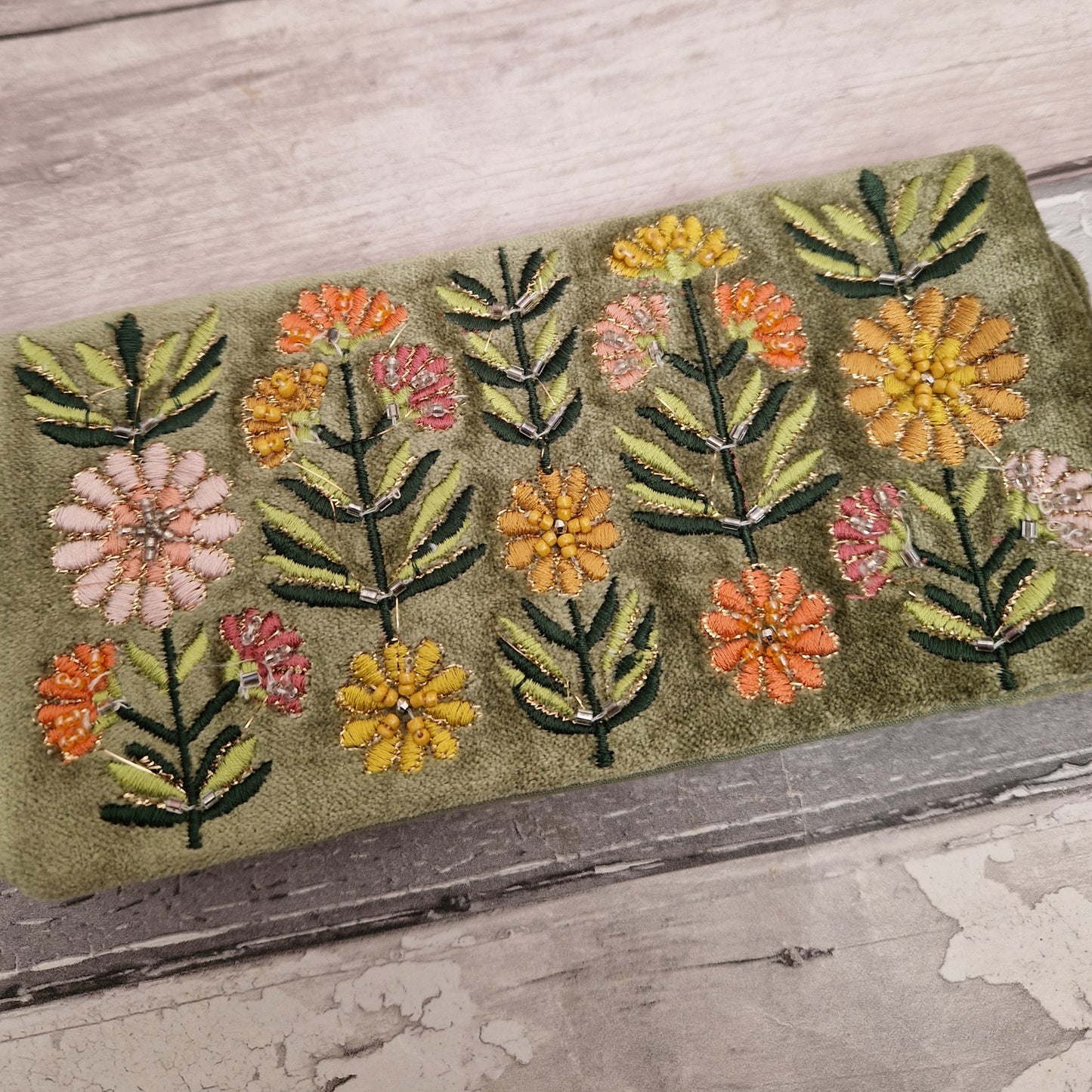 Green Velvet Jewellery Roll decorated with embroidered flowers finished with beading and metallic thread.