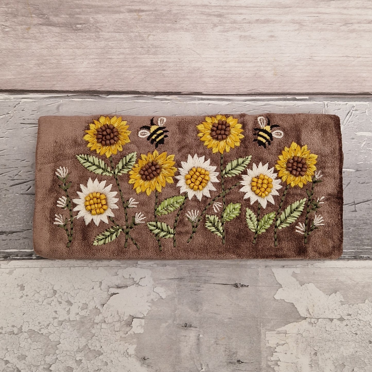 Brown Velvet Jewellery Roll decorated with embroidered sunflowers and bees finished with beading.