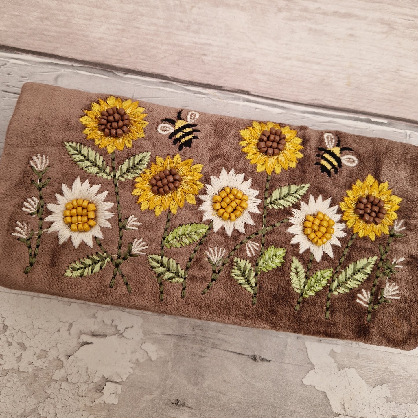 Brown Velvet Jewellery Roll decorated with embroidered sunflowers and bees finished with beading.