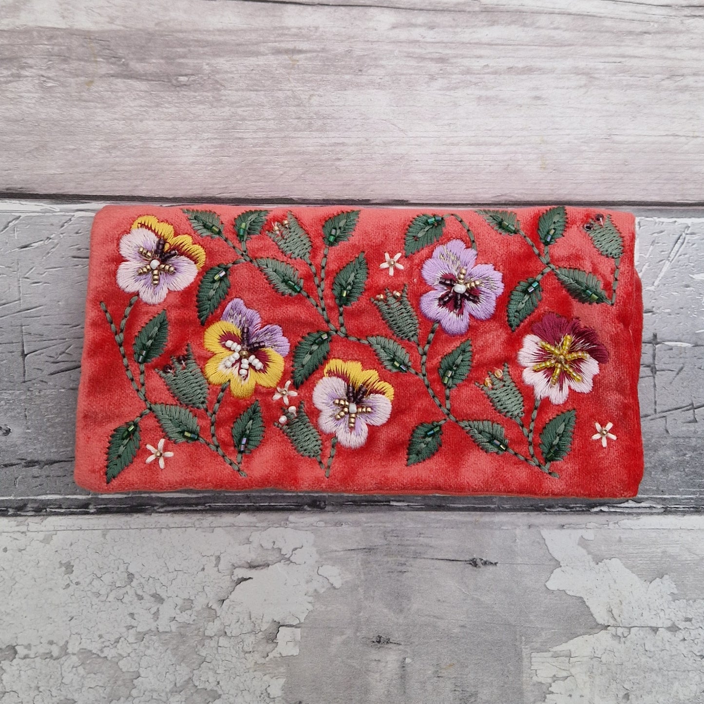 Salmon Velvet Jewellery Roll decorated with embroidered pansies finished with beading.