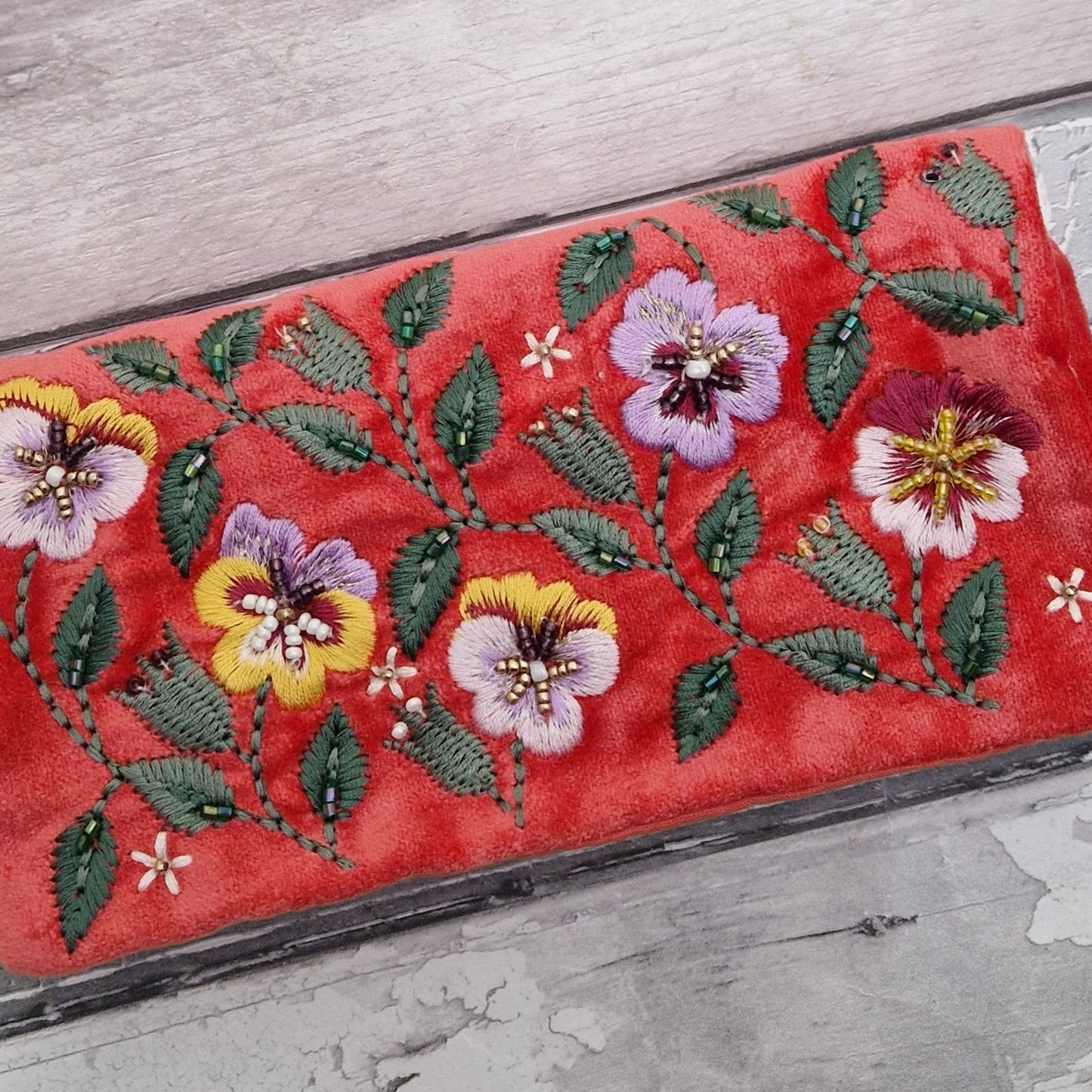 Salmon Velvet Jewellery Roll decorated with embroidered pansies finished with beading.