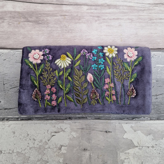 Purple Velvet Jewellery Roll decorated with embroidered flowers finished with beading.