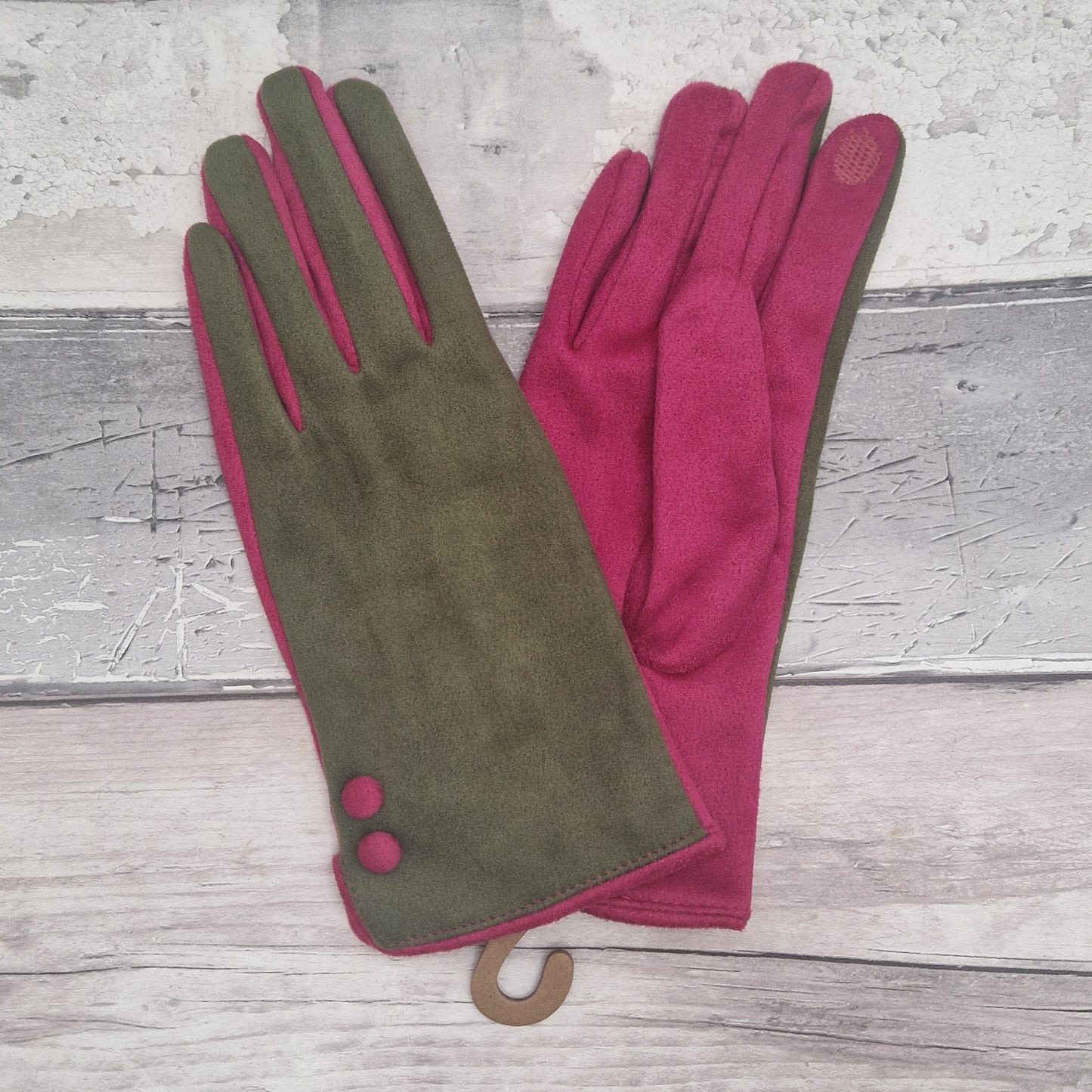 Olive green and hot pink coloured gloves with hot pink buttons.