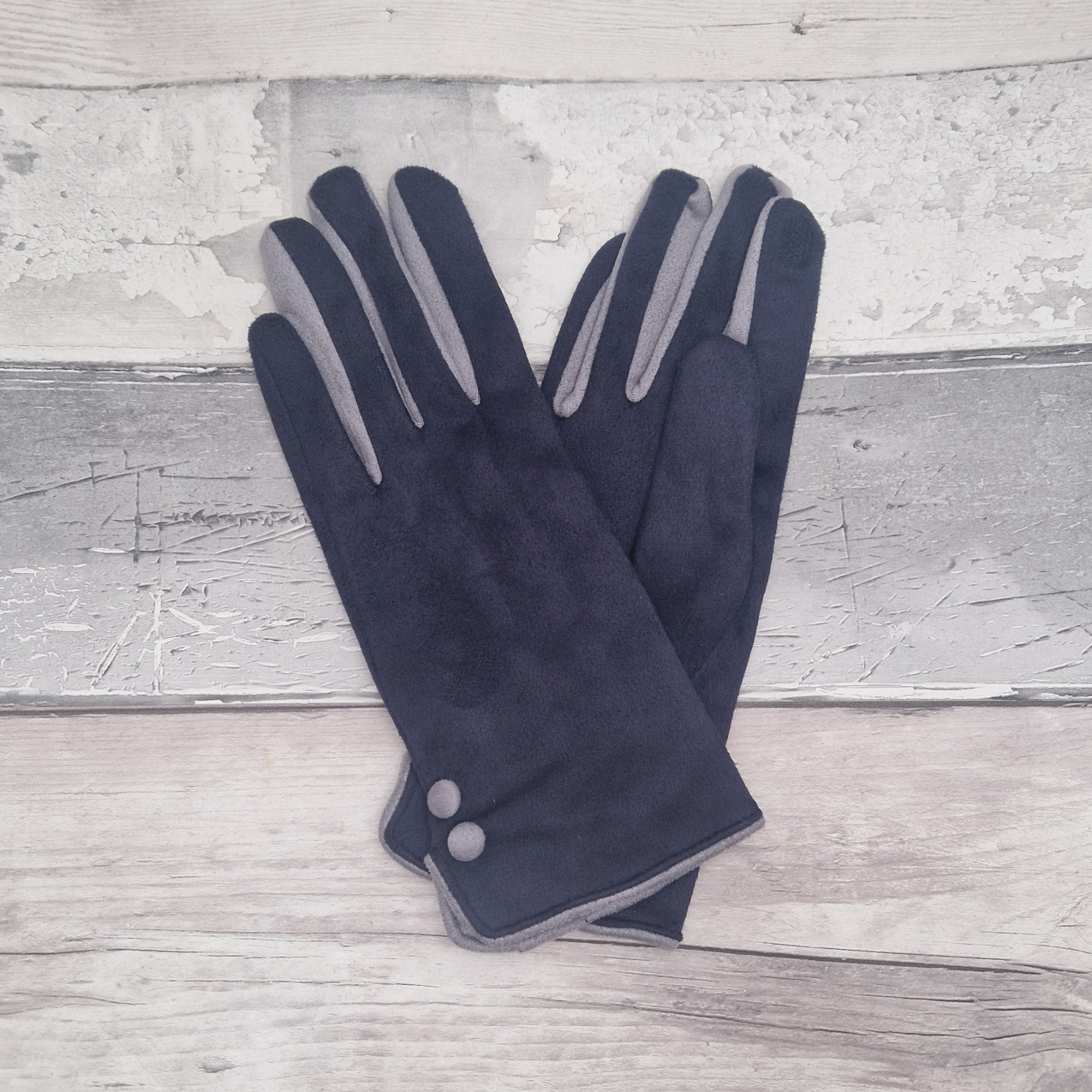 Navy and grey coloured gloves with grey buttons presented in a black gift box.
