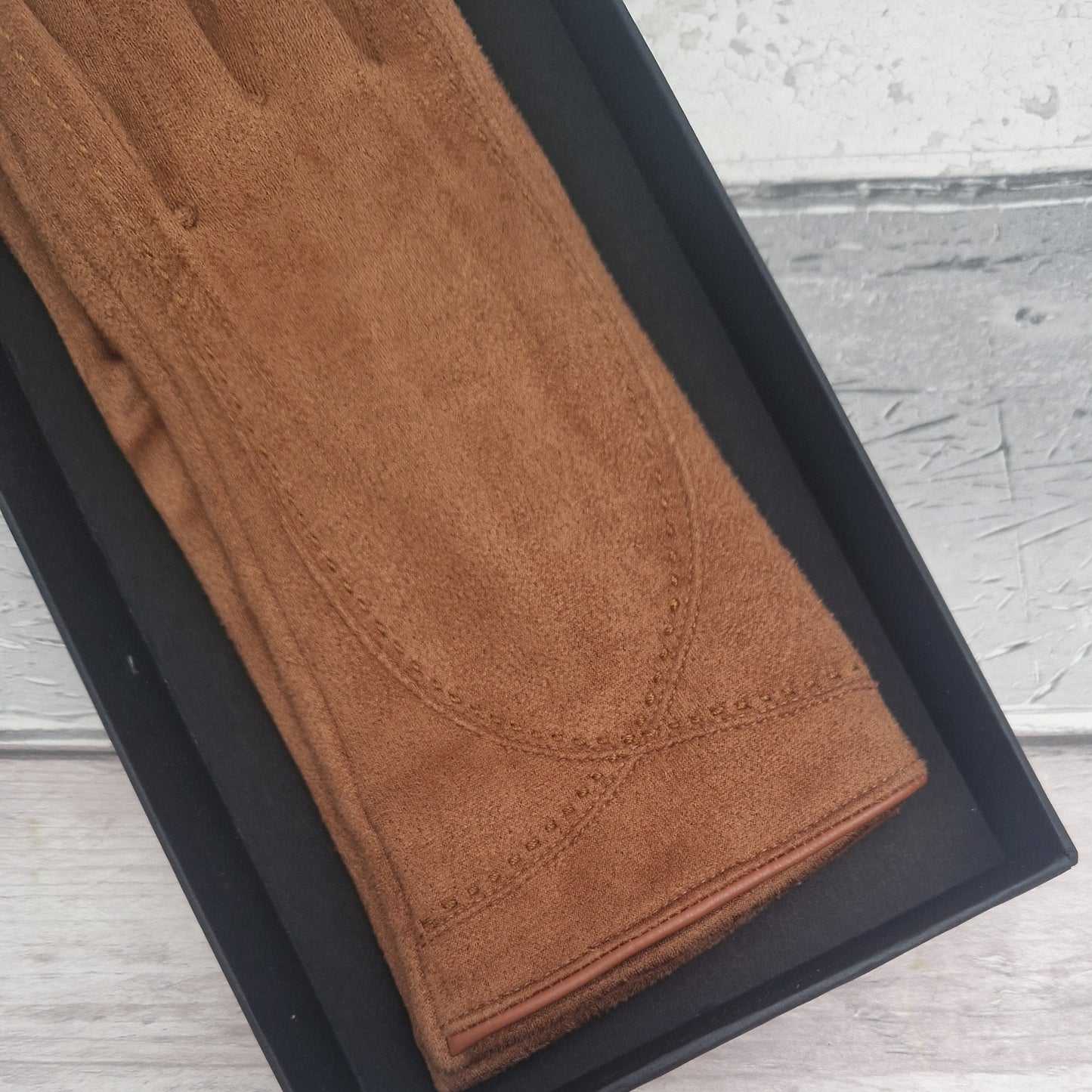 Brown suede feel glove in a black presentation gift box.