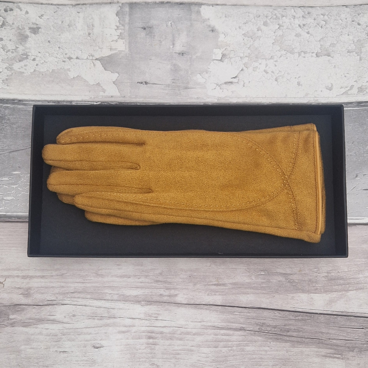 Mustard suede feel glove in a black presentation gift box.