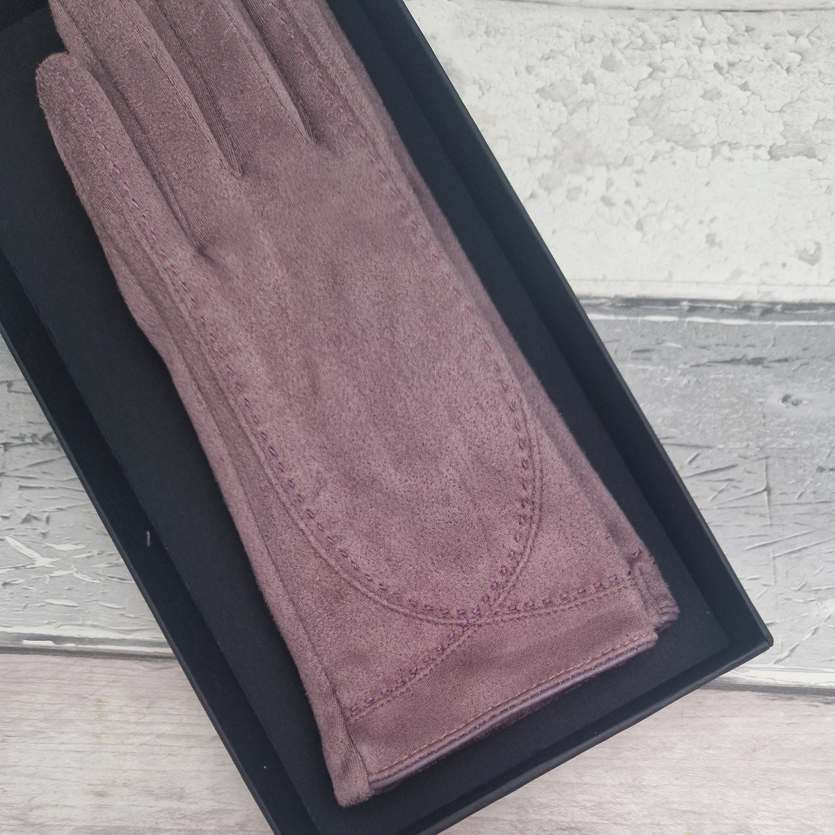 Brown suede feel glove in a black presentation gift box.