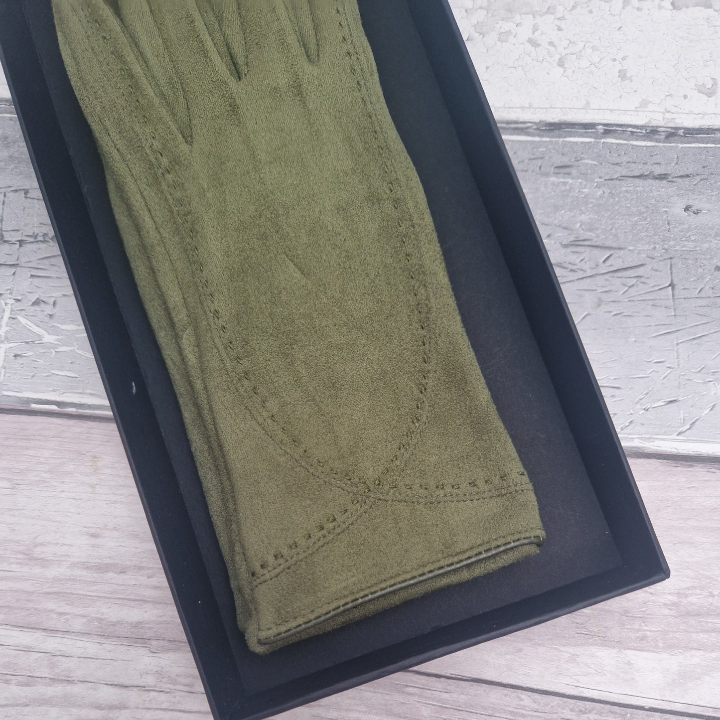 Brown suede feel glove in a black presentation gift box.