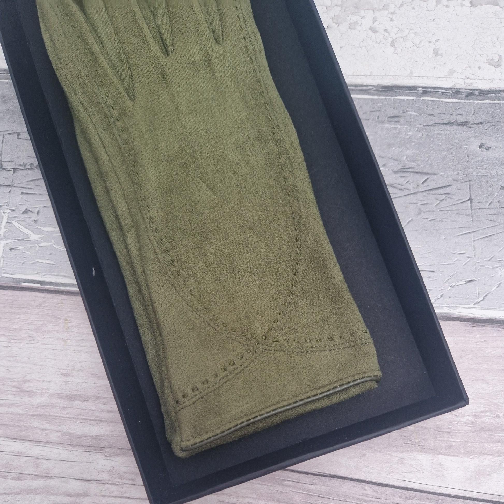 Brown suede feel glove in a black presentation gift box.