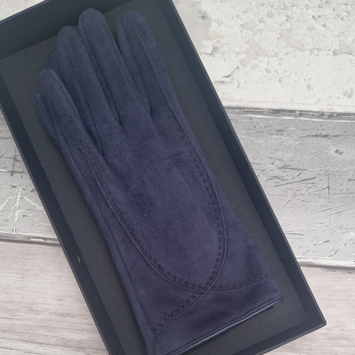 Brown suede feel glove in a black presentation gift box.
