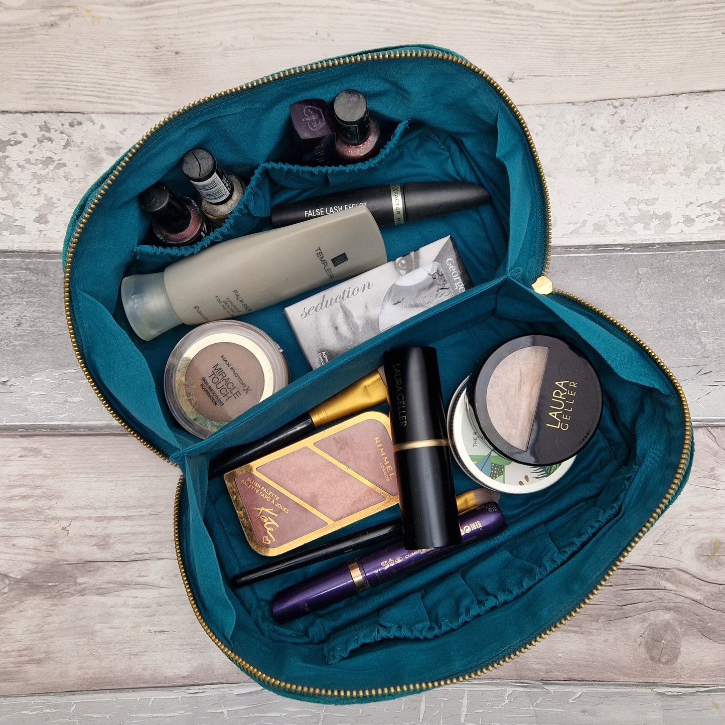 Fold open vanity case in turquois showing contents.