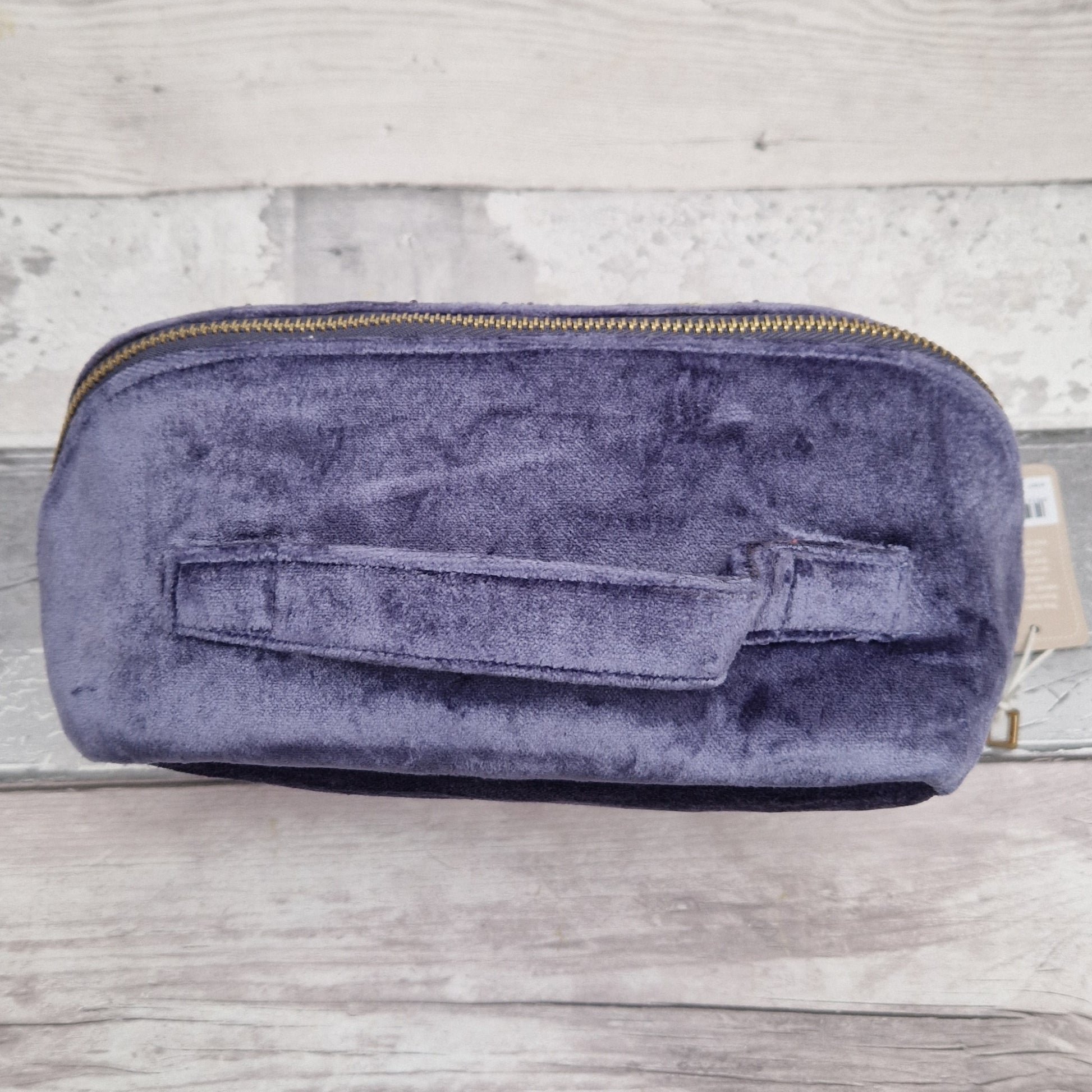 Top view of purple vanity case showing carry handle.