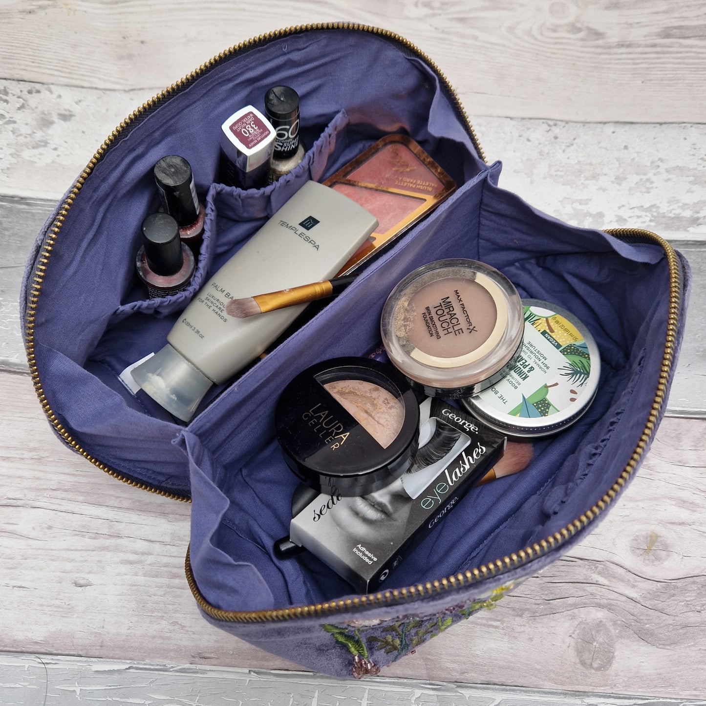 Vanity case filled with make up.
