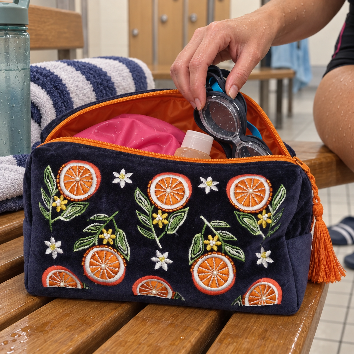 Navy Blue Wash Bag embroidered with slices of orange in use in a gym setting.