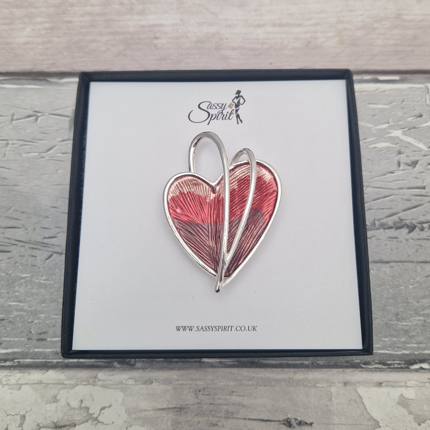 Heart-shaped magnestic brooch on a branded card with 'Sassy Spirit' logo.