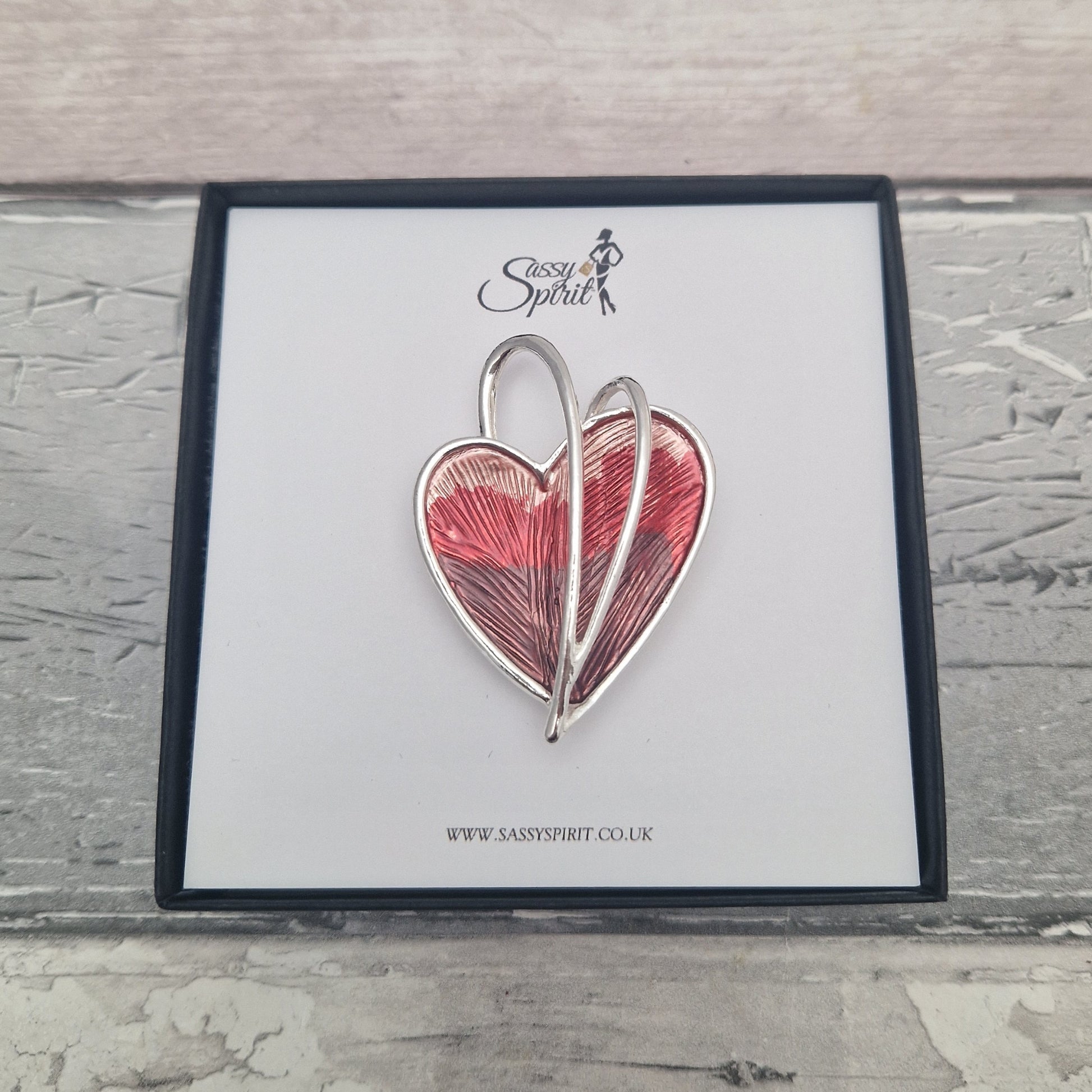 Heart-shaped magnestic brooch on a branded card with 'Sassy Spirit' logo.