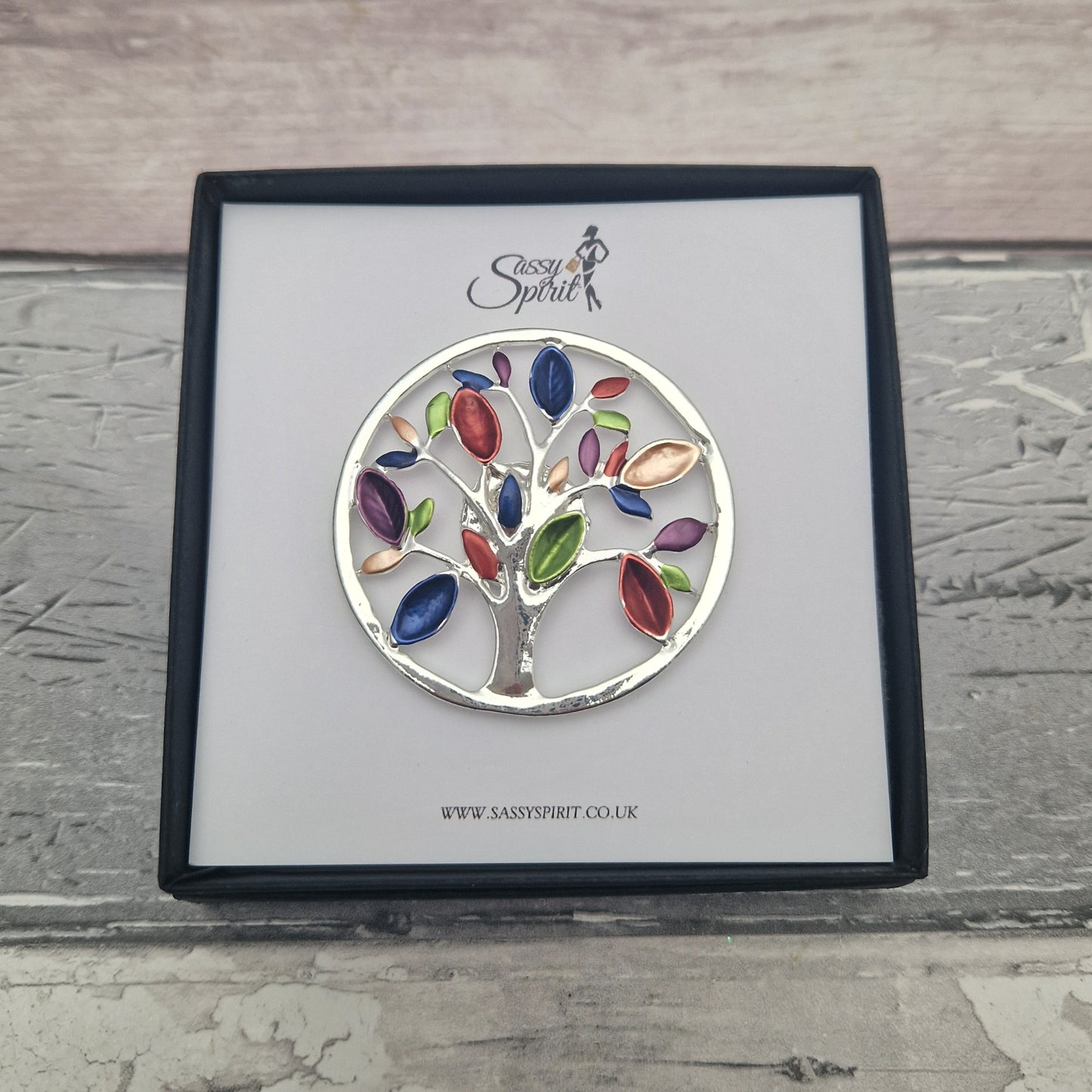 Colorful tree of life magnetic brooch on a branded card with 'Sassy Spirit' logo.