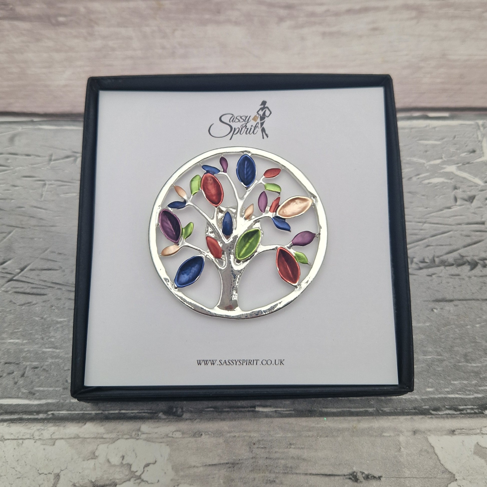 Colorful tree of life magnetic brooch on a branded card with 'Sassy Spirit' logo.