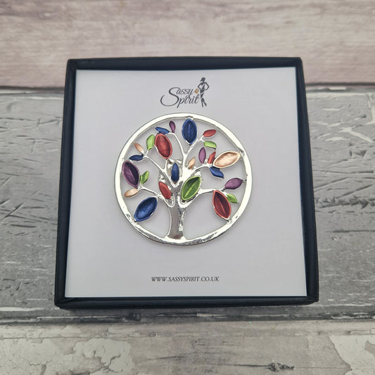 Colorful tree of life magnetic brooch on a branded card with 'Sassy Spirit' logo.