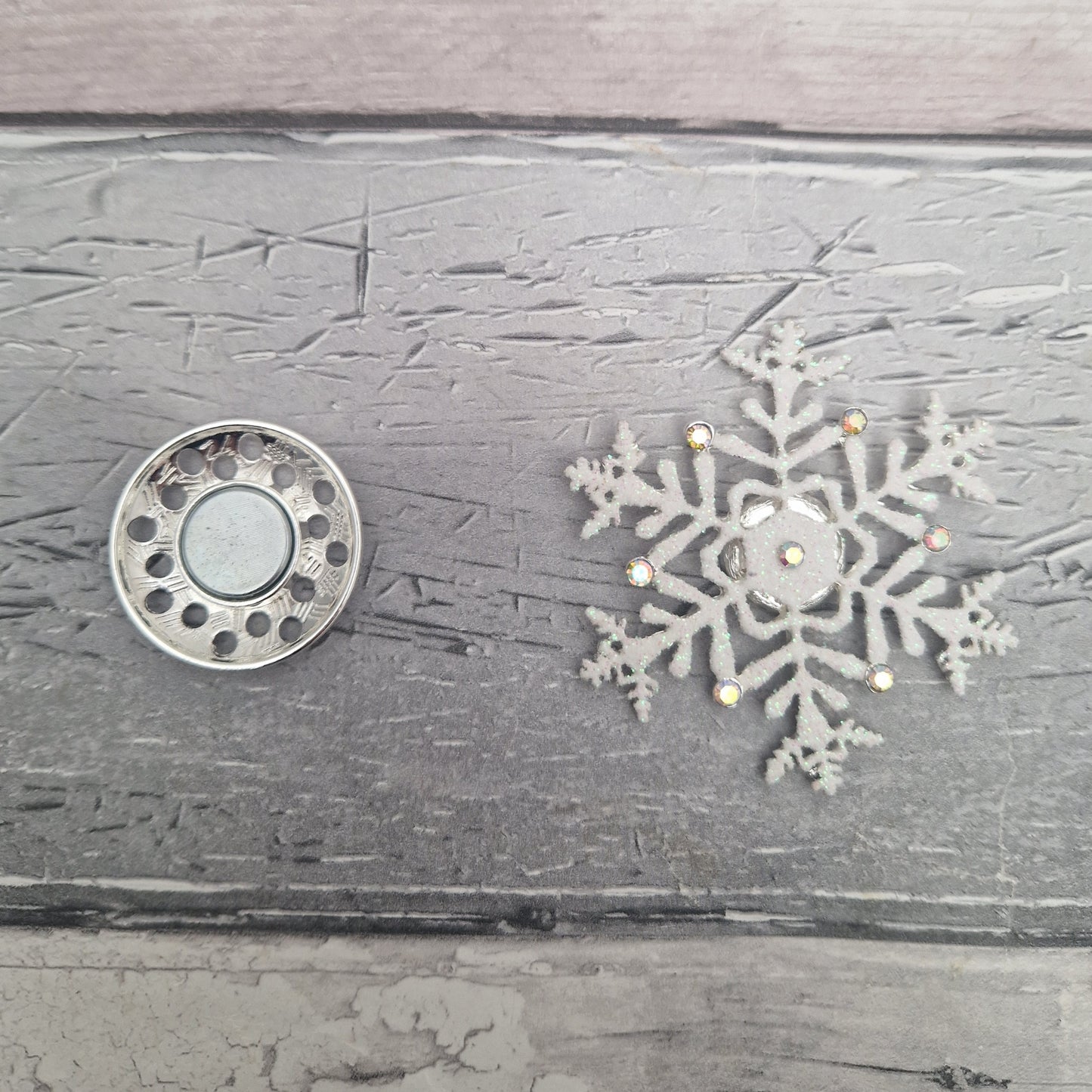 2 parts of a magnetic snowflake brooch