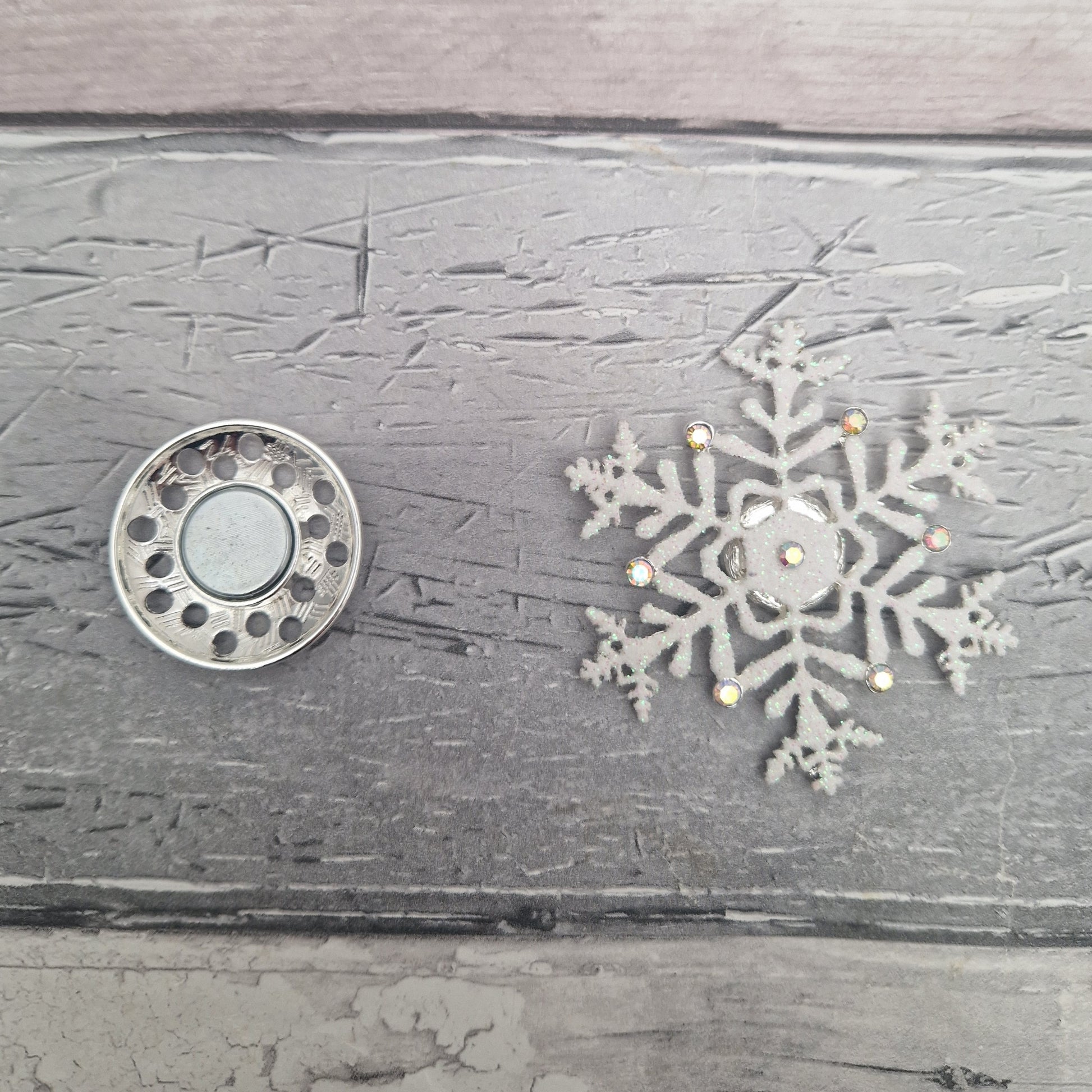 2 parts of a magnetic snowflake brooch