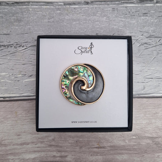 New Zealand Paua Shell decorates the swirl shaped magnetic brooch, presented in a black gift box.