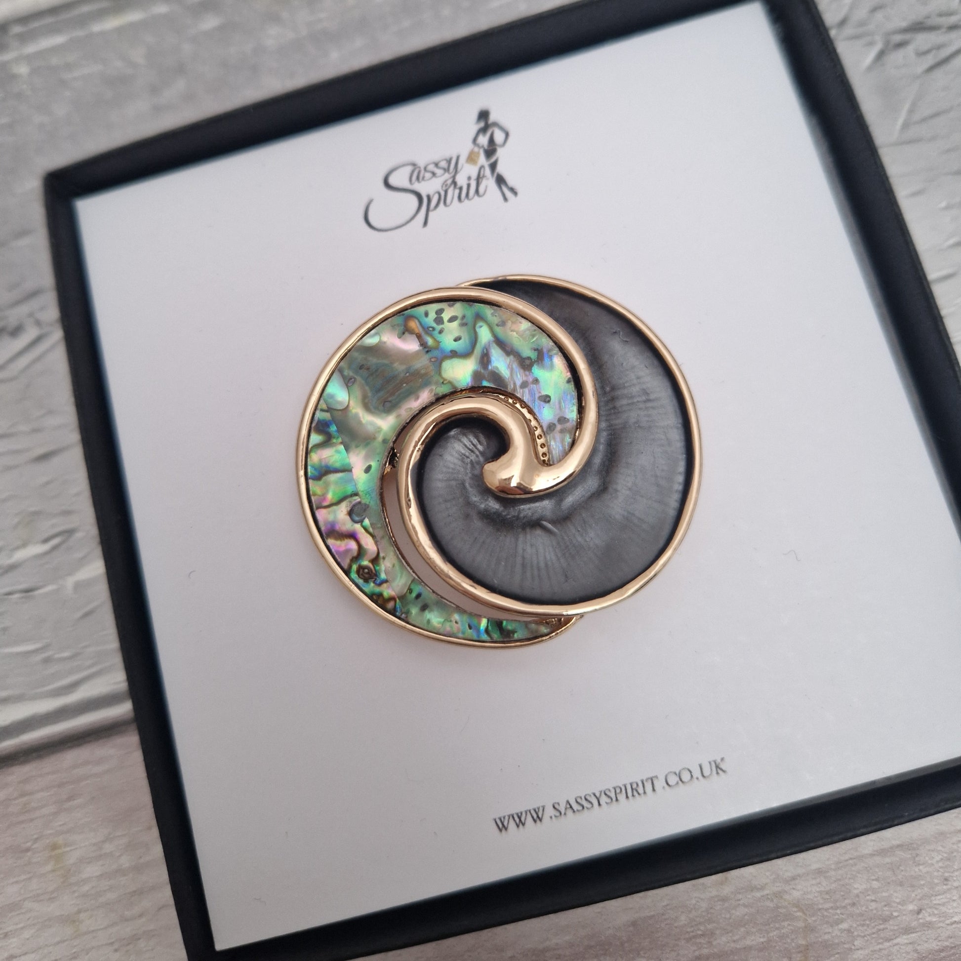 New Zealand Paua Shell swirl shaped brooch in a black gift box.