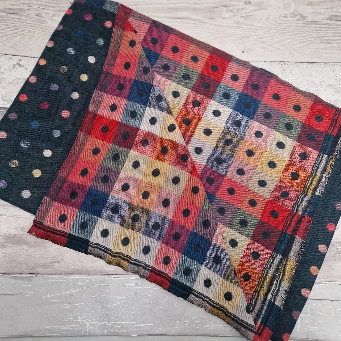 Reversible forest green spot scarf with multicoloured chequered squares.