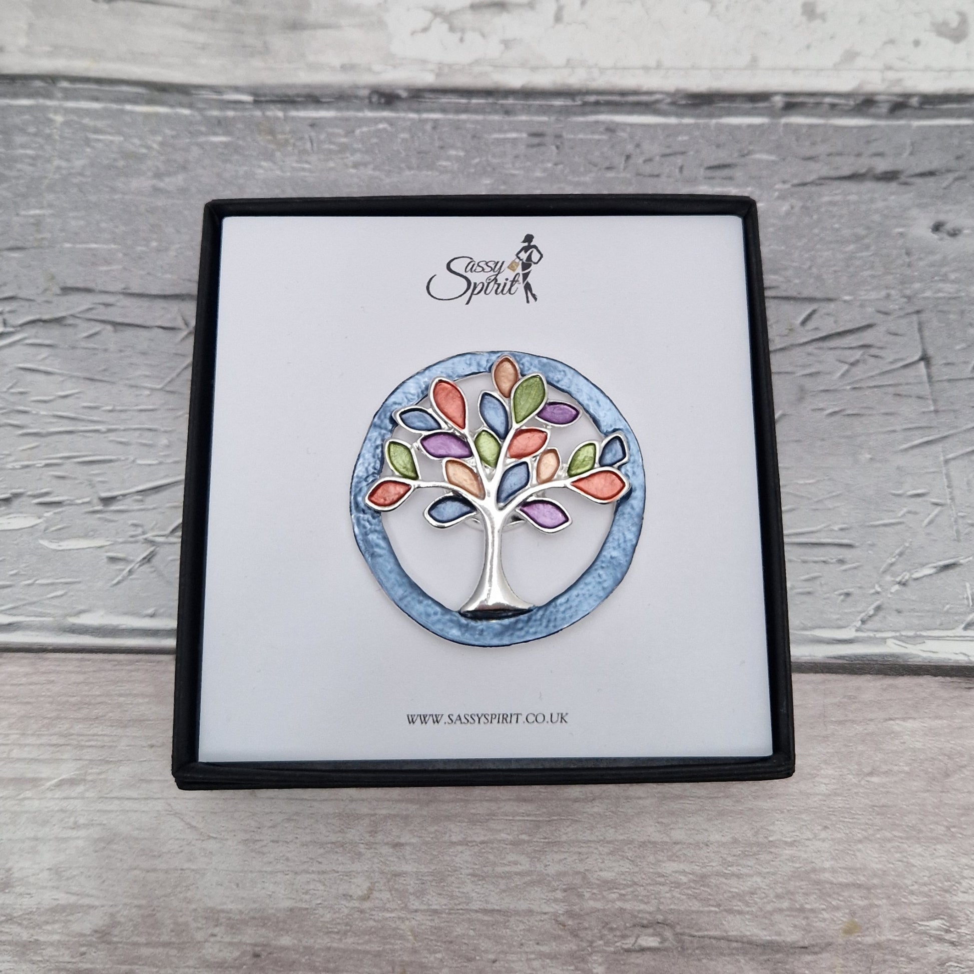 Tree-shaped brooch on a branded card with 'Sassy Spirit' logo.