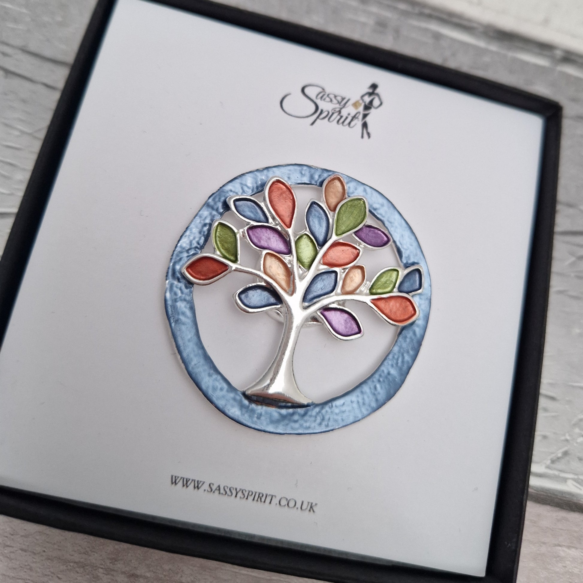 Tree-shaped brooch on a branded card with 'Sassy Spirit' logo.
