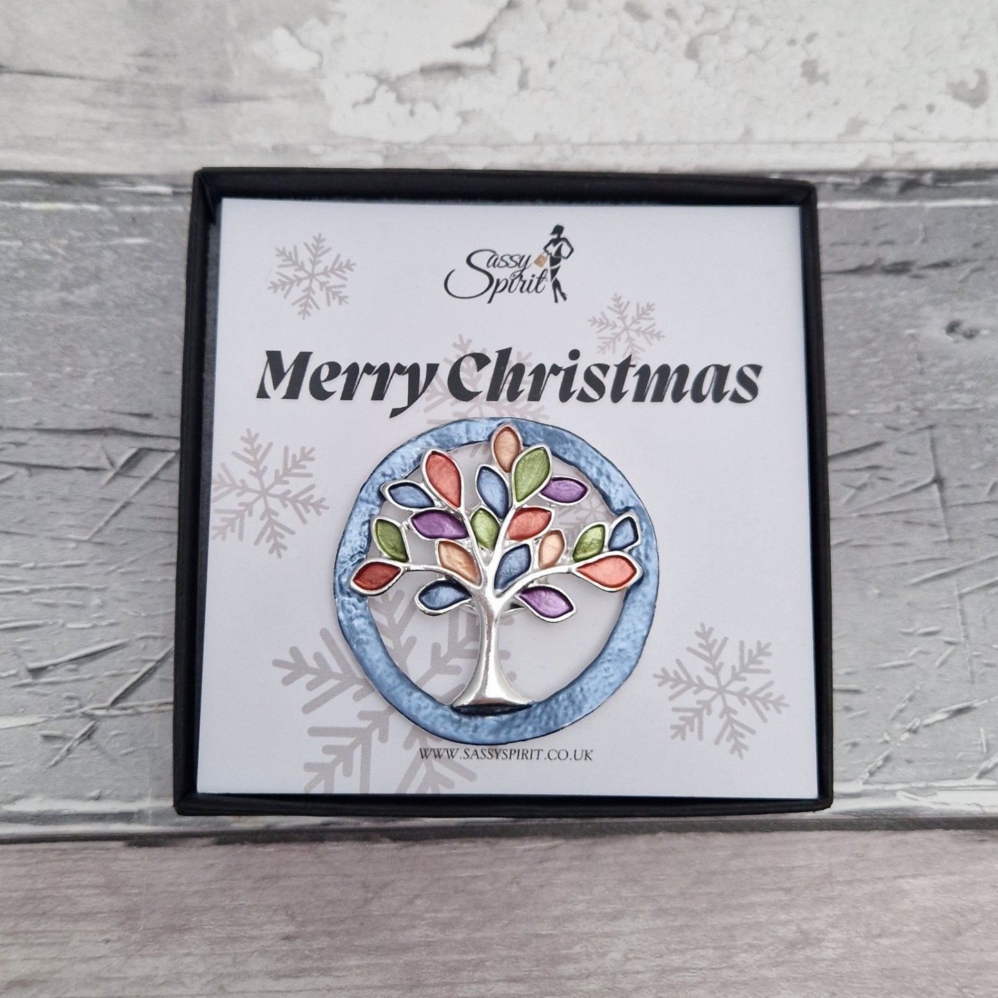 Tree-shaped brooch on a branded card with 'Sassy Spirit' logo.