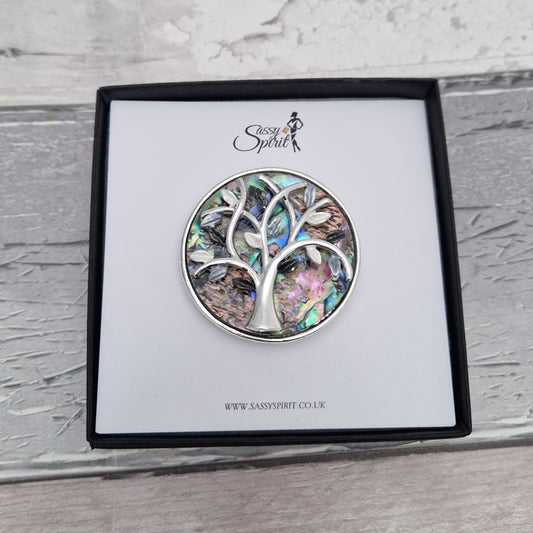Paua Shell inlaid brooch decorated with a silver tone tree of life. Presented in a Sassy Spirit Gift Box.
