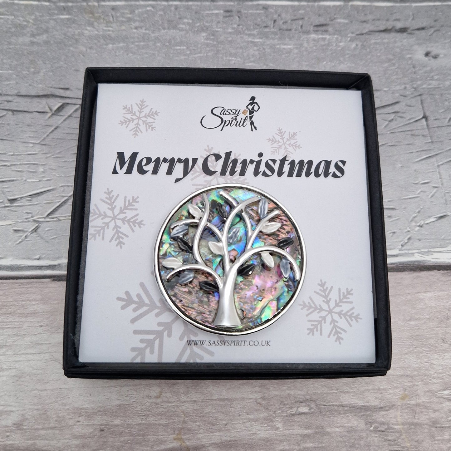 Paua Shell inlaid brooch decorated with a silver tone tree of life. Presented in a Sassy Spirit Gift Box.