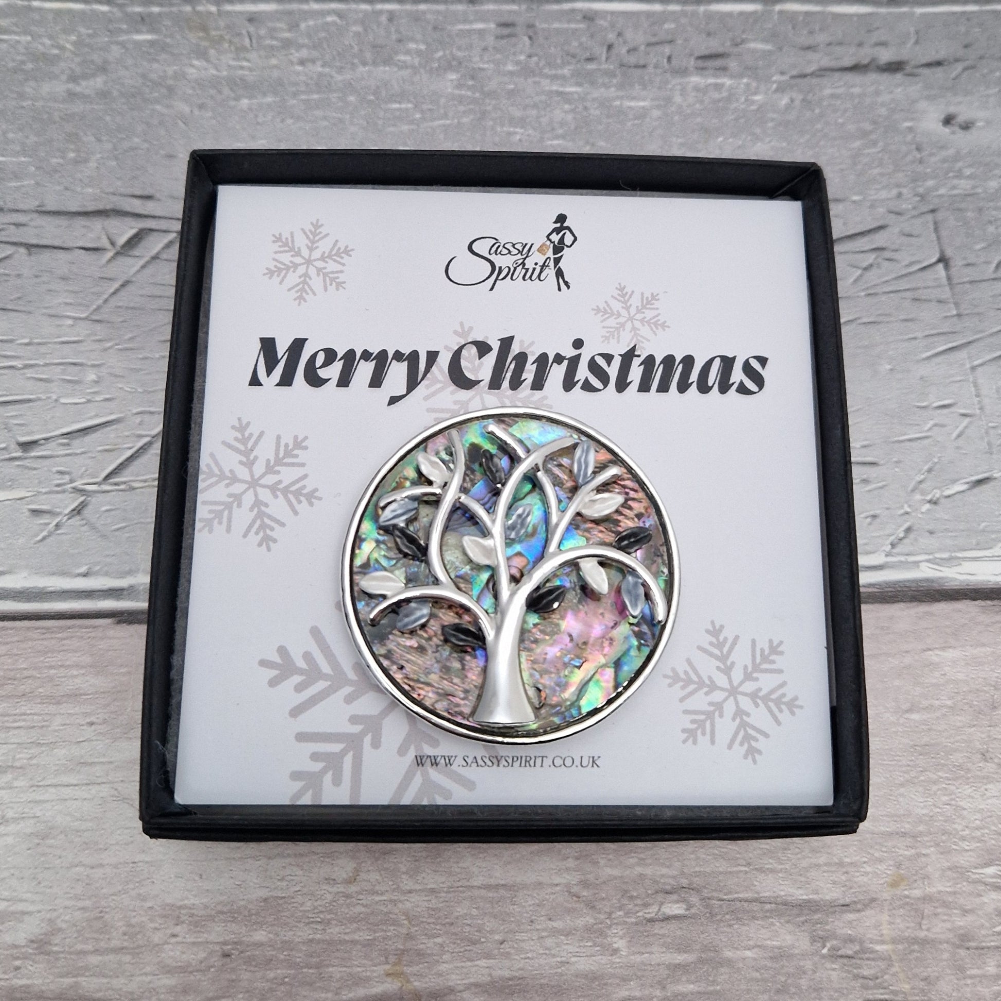 Paua Shell inlaid brooch decorated with a silver tone tree of life. Presented in a Sassy Spirit Gift Box.