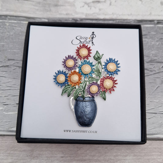 Colorful flower bouquet brooch in a box with 'Sassy Spirit' branding.