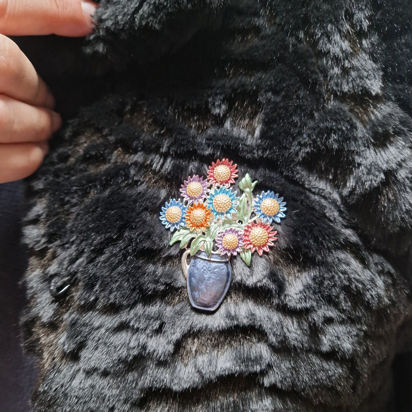 Floral brooch on a black fur coat