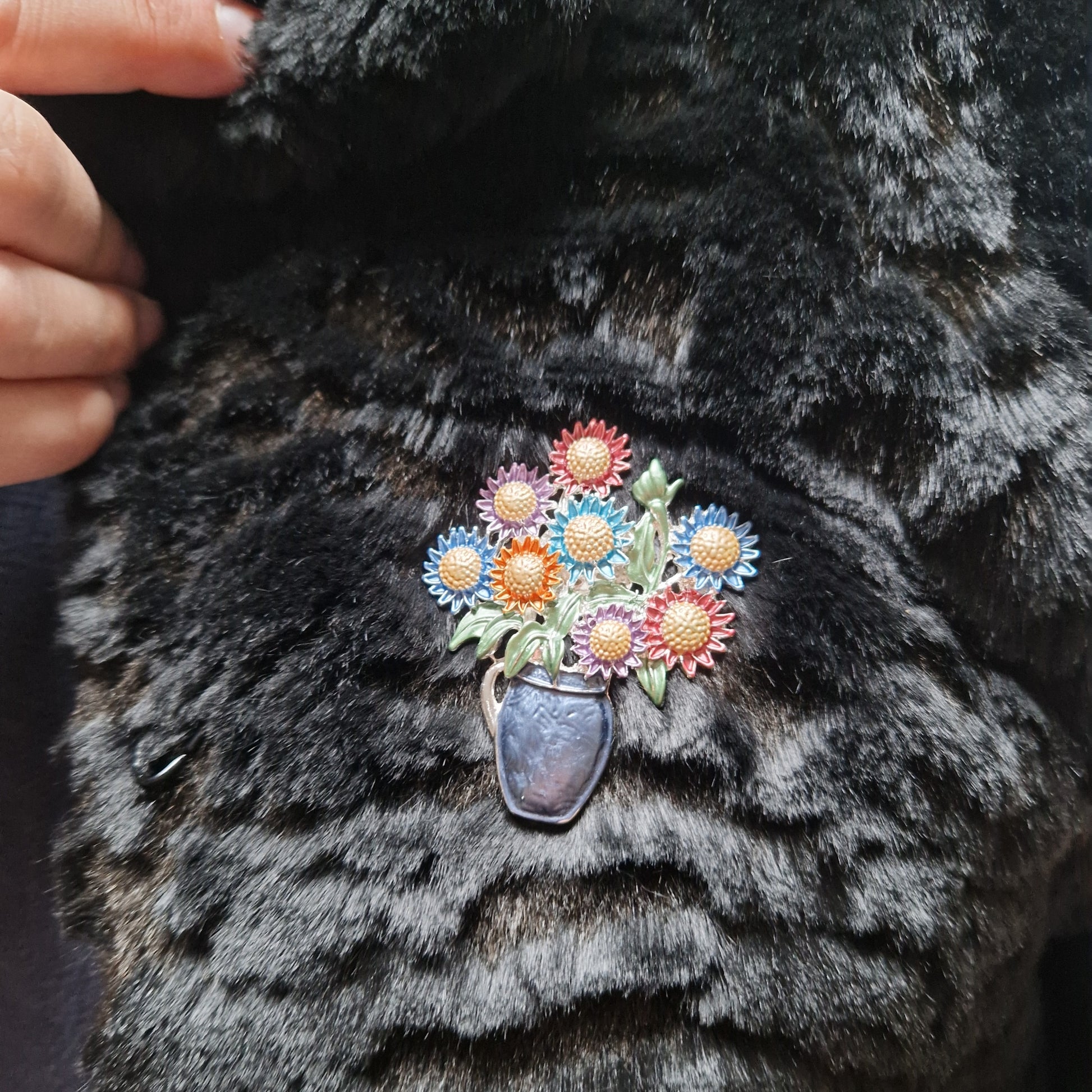 Floral brooch on a black fur coat